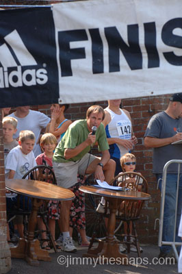 Race Director Stuart Mills in Action on the Microphone at the Finish